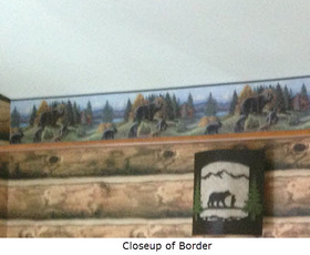 Close up of bedroom wallpaper showing north woods border
